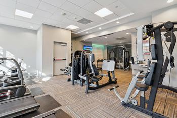 A gym with weights and cardio equipment in a building